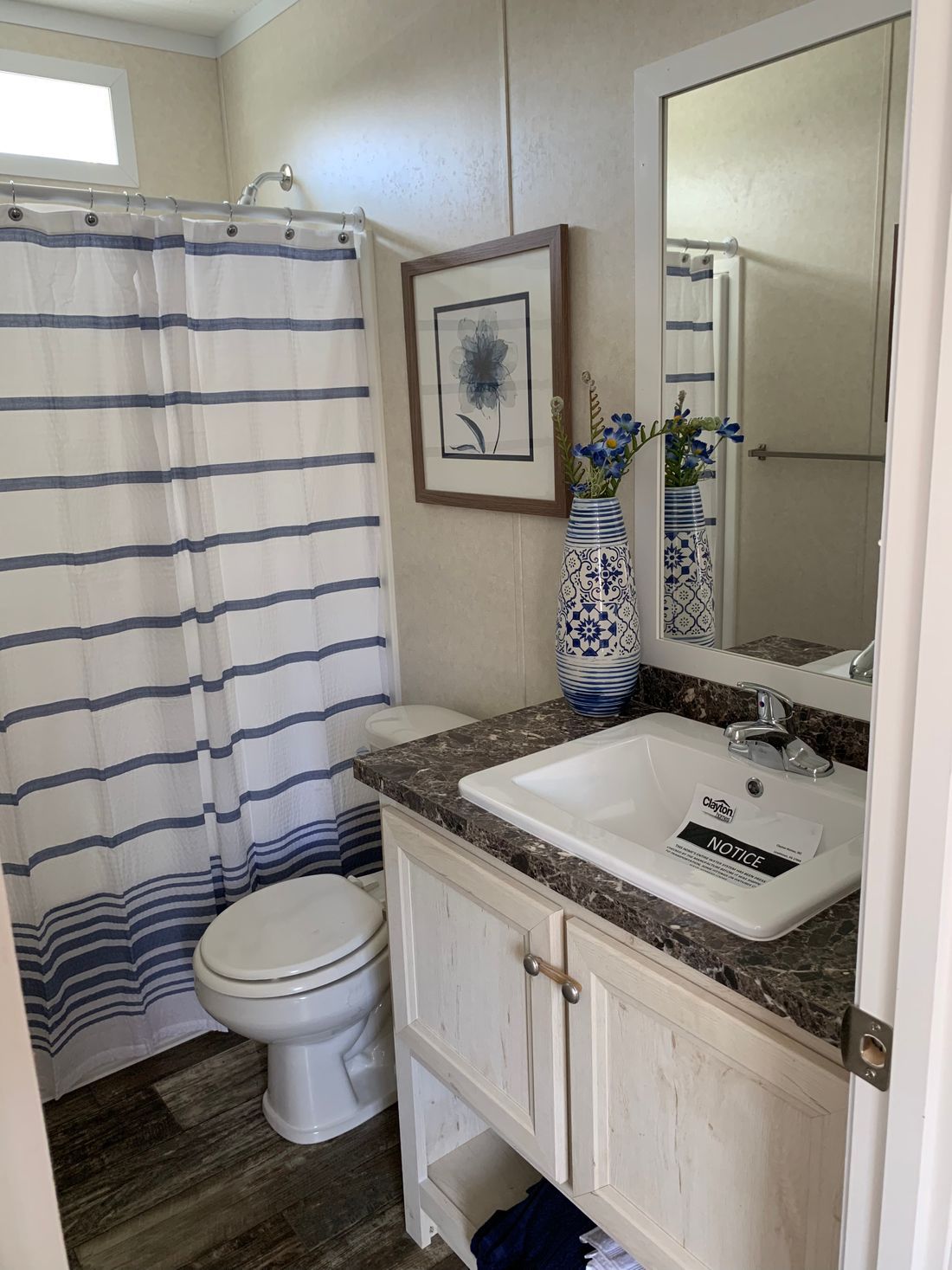 The LAWRENCE 7016-707 Guest Bathroom. This Manufactured Mobile Home features 3 bedrooms and 2 baths.